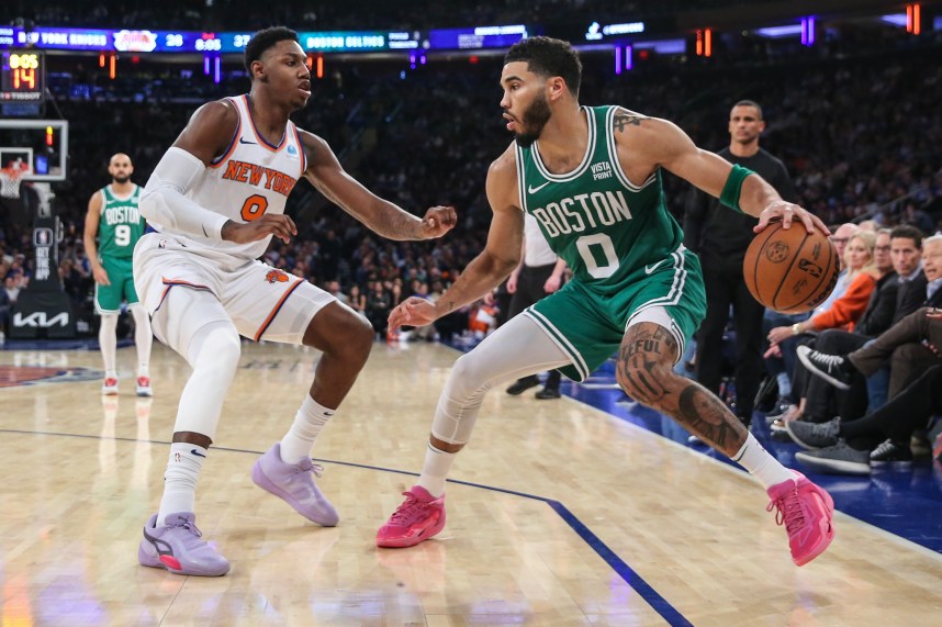 Boston Celtics forward Jayson Tatum (0) looks to drive past New York Knicks guard RJ Barrett (9) in the second quarter at Madison Square Garden