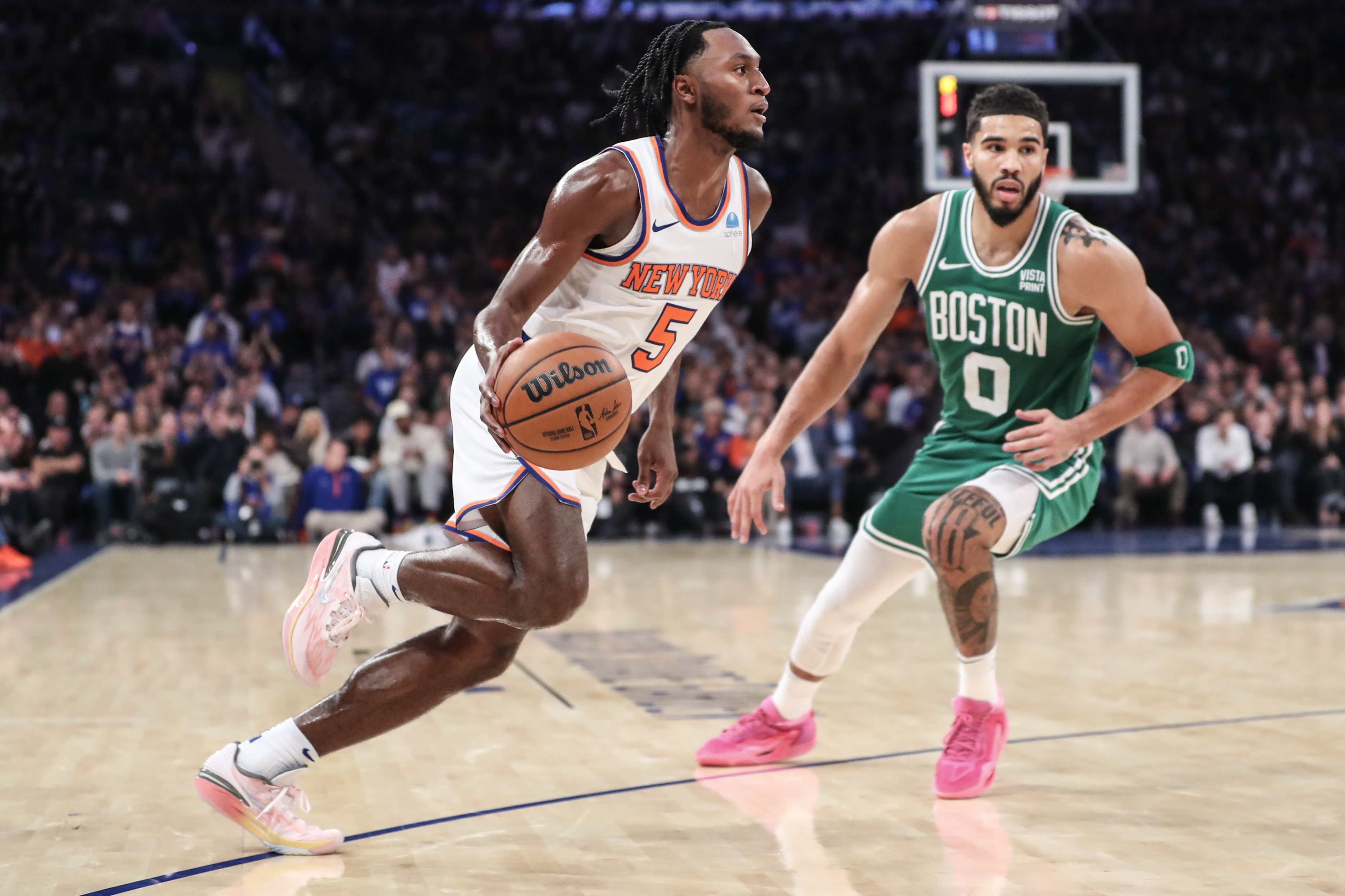 New York Knicks guard Immanuel Quickley (5) looks to drive past Boston Celtics forward Jayson Tatum (0) in the fourth quarter at Madison Square Garden