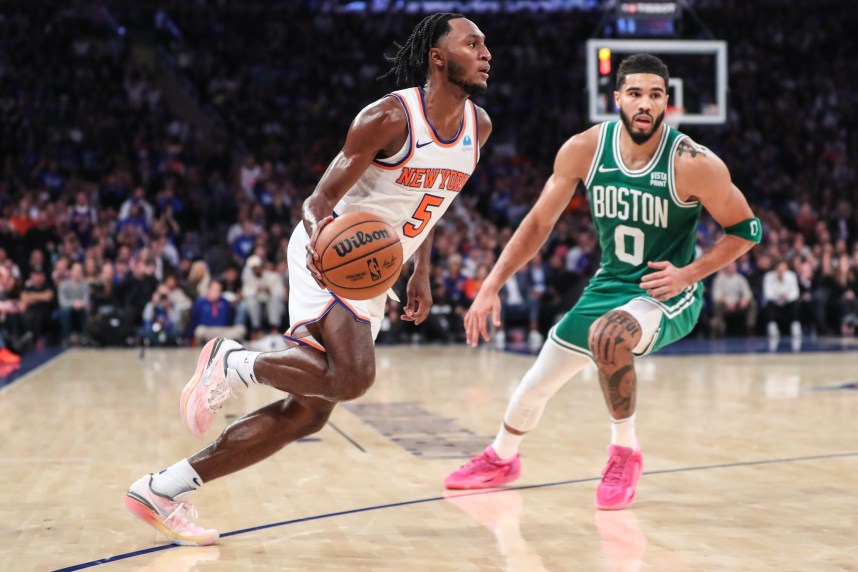 New York Knicks guard Immanuel Quickley (5) looks to drive past Boston Celtics forward Jayson Tatum (0) in the fourth quarter at Madison Square Garden