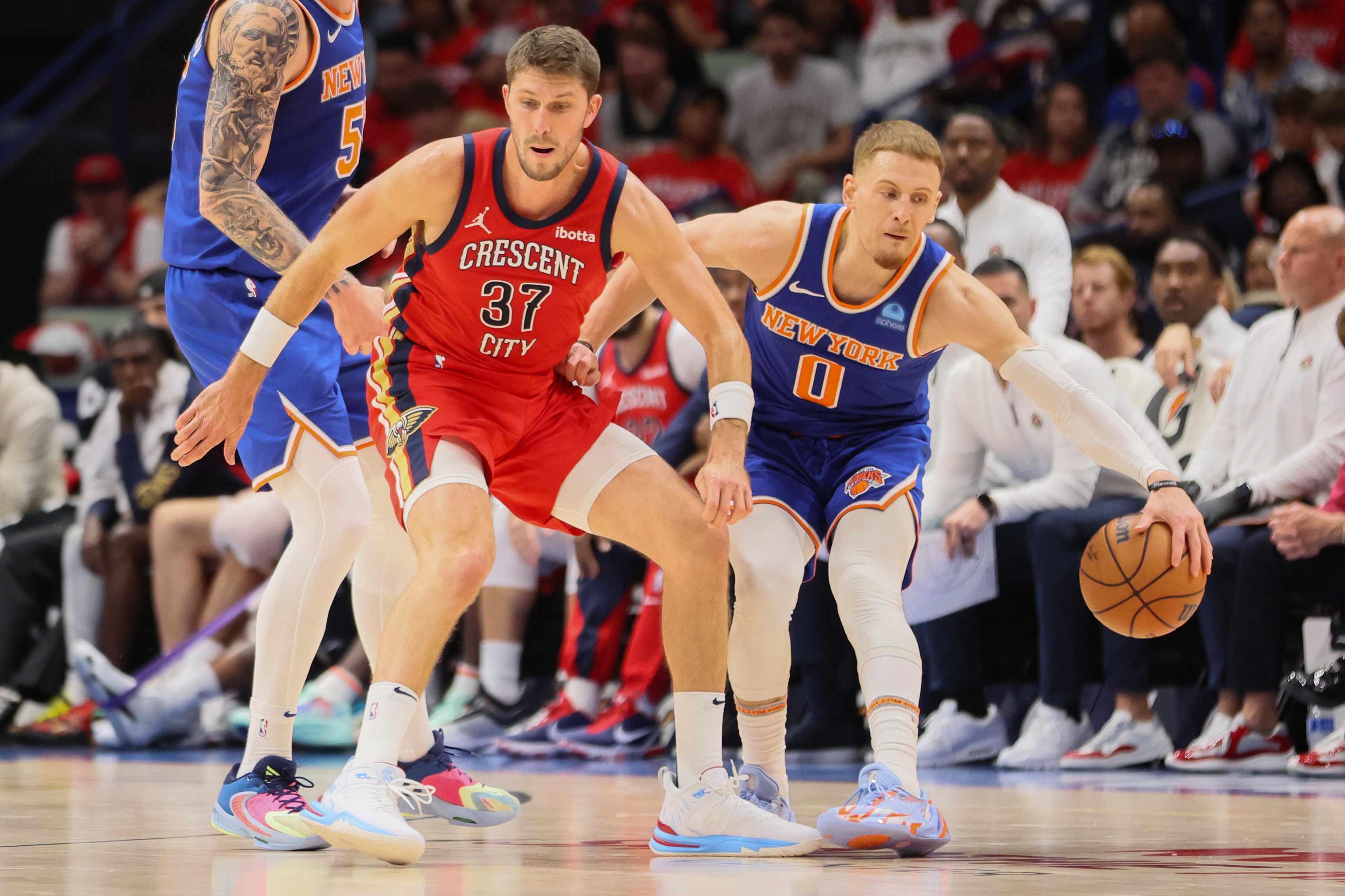 New Orleans Pelicans forward Matt Ryan (37) tries to steal the ball from New York Knicks guard Donte DiVincenzo (0) in the third quarter at Smoothie King Center