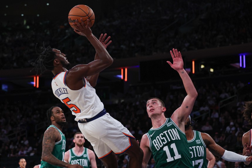 New York Knicks guard Immanuel Quickley (5) shoots the ball as Boston Celtics guard Payton Pritchard (11) defends during the second half at Madison Square Garden