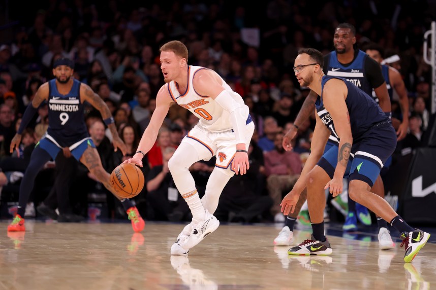 New York Knicks guard Donte DiVincenzo (0) controls the ball against Minnesota Timberwolves forward Kyle Anderson (1) during the second quarter at Madison Square Garden