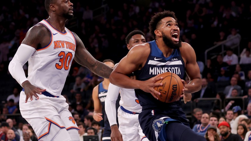 Minnesota Timberwolves center Karl-Anthony Towns (32) drives to the basket against New York Knicks forward Julius Randle (30) and guard RJ Barrett (9) during the first quarter at Madison Square Garden