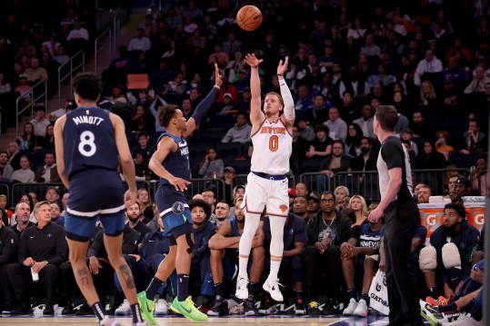 New York Knicks guard Donte DiVincenzo (0) three point shot against Minnesota Timberwolves guard Wendell Moore Jr. (7) and forward Josh Minott (8) during the fourth quarter at Madison Square Garden