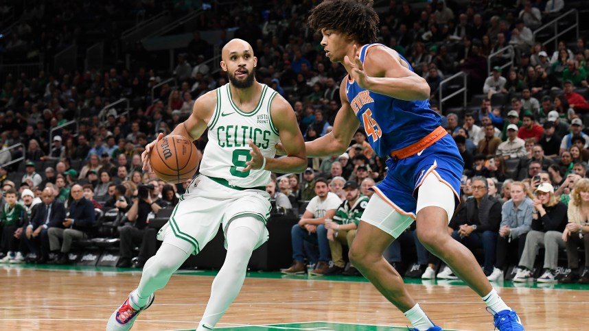 Boston Celtics guard Derrick White (9) controls the ball while New York Knicks center Jericho Sims (45) defends during the first half at TD Garden