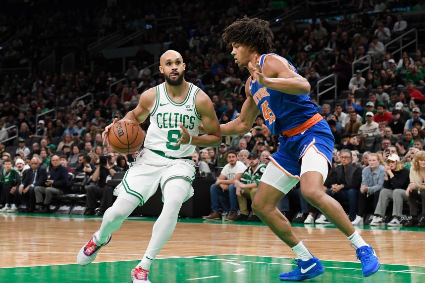 Boston Celtics guard Derrick White (9) controls the ball while New York Knicks center Jericho Sims (45) defends during the first half at TD Garden