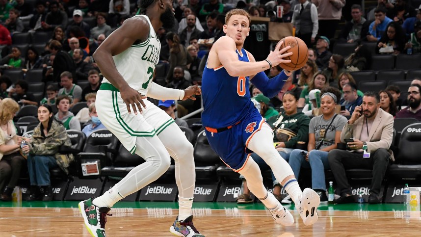 New York Knicks guard Donte DiVincenzo (0) drives to the basket while Boston Celtics guard Jaylen Brown (7) defends during the second half at TD Garden