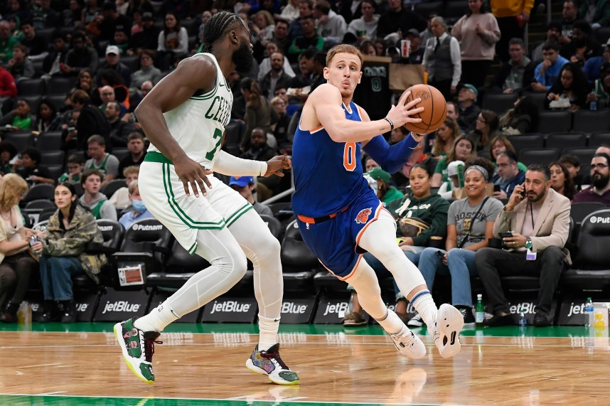 New York Knicks guard Donte DiVincenzo (0) drives to the basket while Boston Celtics guard Jaylen Brown (7) defends during the second half at TD Garden