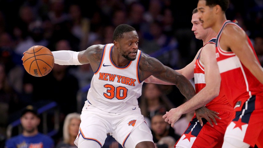 New York Knicks forward Julius Randle (30) controls the ball against Washington Wizards forward Danilo Gallinari (88) and guard Jordan Poole (13) during the third quarter at Madison Square Garden