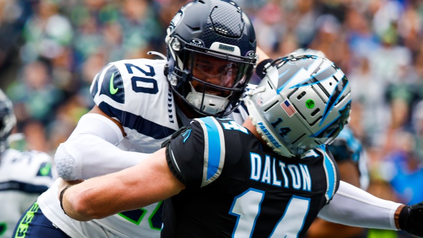 Seattle Seahawks safety Julian Love (20) hits Carolina Panthers quarterback Andy Dalton (14) following a pass attempt by Dalton during the first quarter at Lumen Field, Giants
