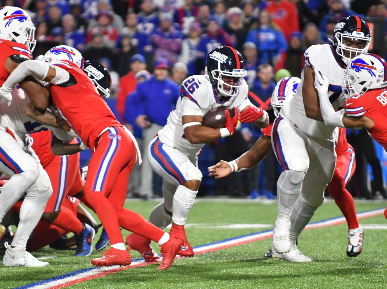 New York Giants running back Saquon Barkley (26) carries the ball against the Buffalo Bills in the second quarter at Highmark Stadium