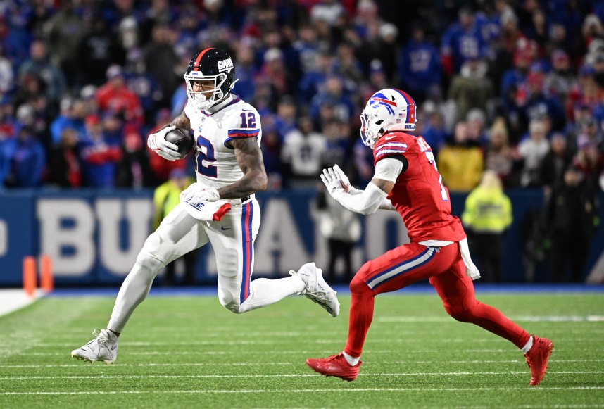 New York Giants tight end Darren Waller (12) gets out of bounds before being hit by Buffalo Bills cornerback Taron Johnson (7) in the fourth quarter at Highmark Stadium