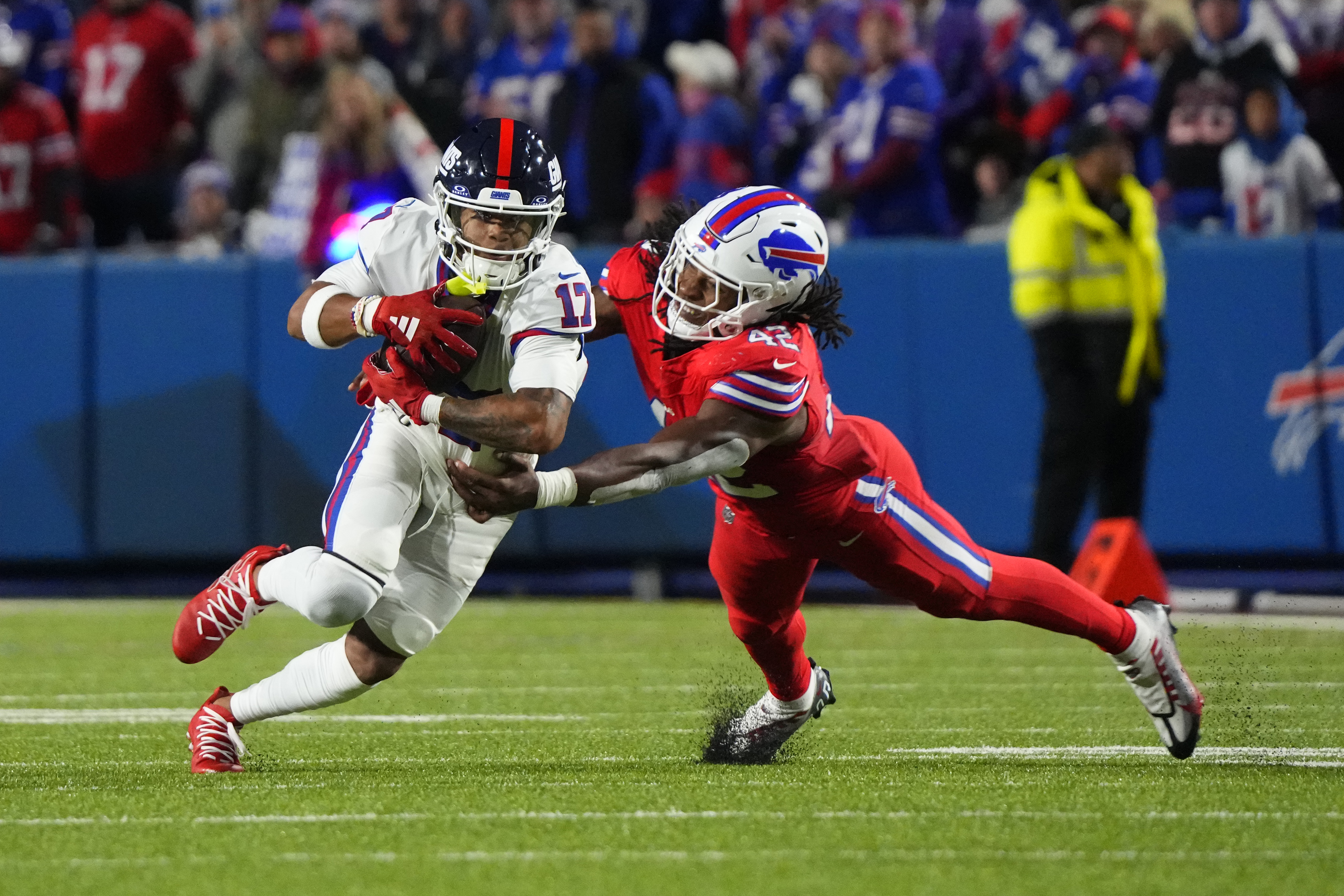 Buffalo Bills linebacker Dorian Williams (42) tackles New York Giants wide receiver Wan'Dale Robinson (17) running with the ball during the second half at Highmark Stadium