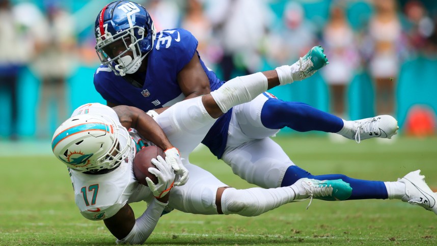 Miami Dolphins wide receiver Jaylen Waddle (17)catches the football against New York Giants cornerback Tre Hawkins III (37) during the second quarter at Hard Rock Stadium