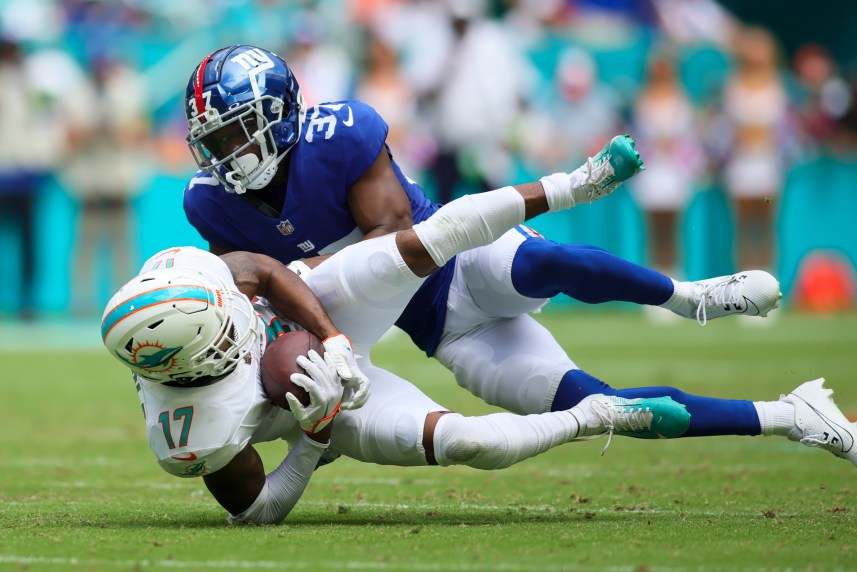 Miami Dolphins wide receiver Jaylen Waddle (17)catches the football against New York Giants cornerback Tre Hawkins III (37) during the second quarter at Hard Rock Stadium