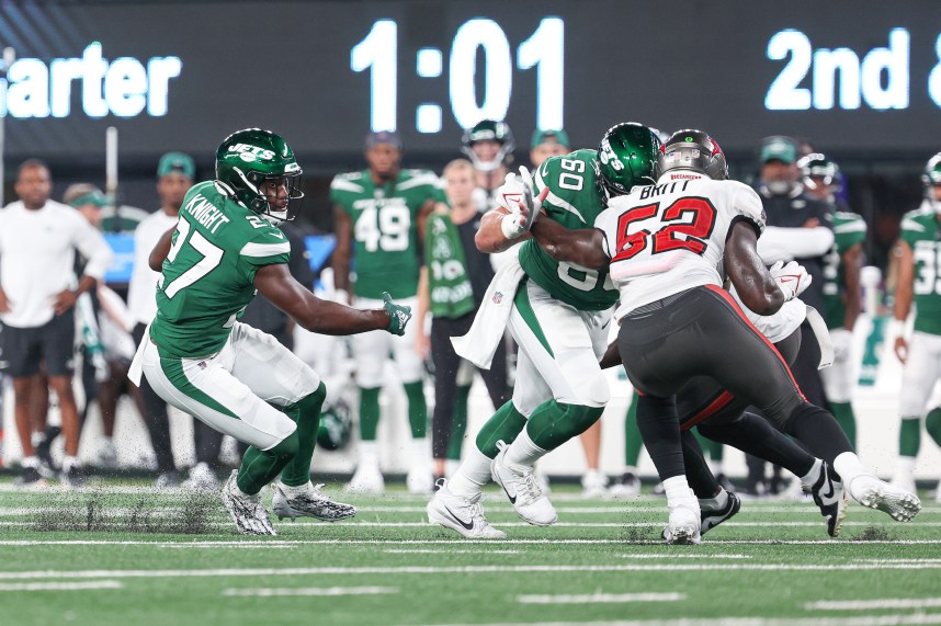 New York Jets running back Zonovan Knight (27) carries the ball as center Connor McGovern (60) blocks Tampa Bay Buccaneers linebacker K.J. Britt (52) during the first half at MetLife Stadium