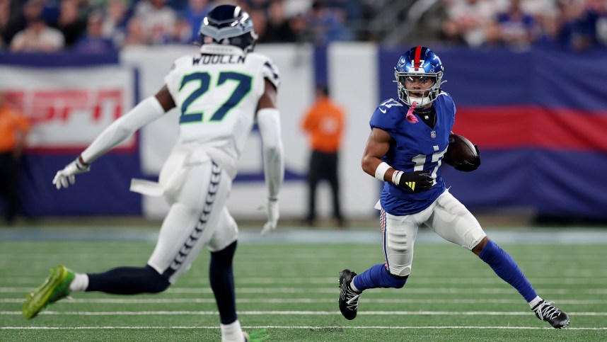 New York Giants wide receiver Wan'Dale Robinson (17) runs with the ball against Seattle Seahawks cornerback Riq Woolen (27) during the first quarter at MetLife Stadium