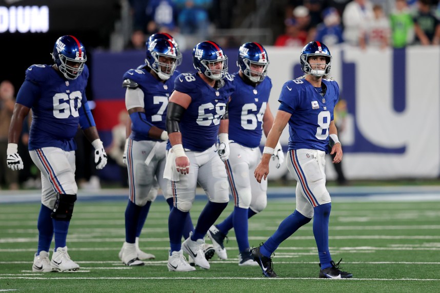 New York Giants quarterback Daniel Jones (8) walks off the field with guards Marcus McKethan (60) and Joshua Ezeudu (75) and Ben Bredeson (68) and Mark Glowinski (64) after being sacked during the fourth quarter against the Seattle Seahawks at MetLife Stadium