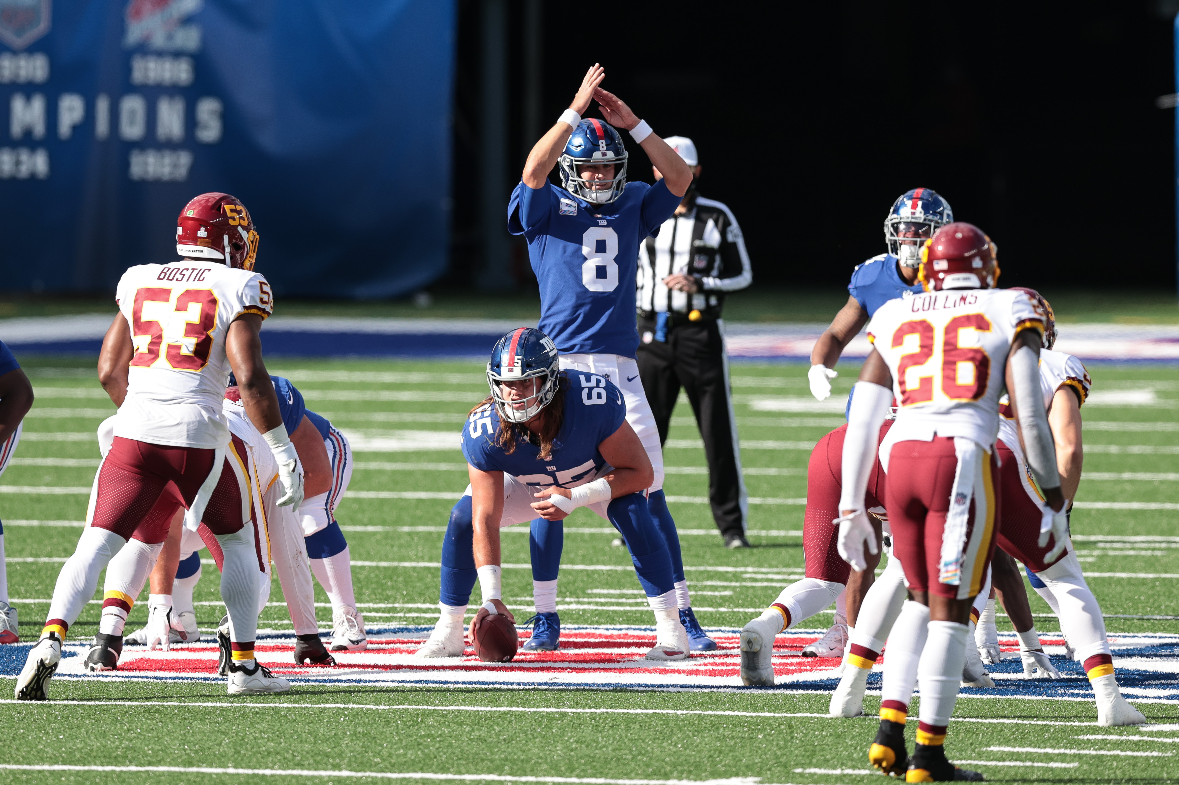 New York Giants quarterback Daniel Jones (8) calls time out behind guard Nick Gates (65) as Washington Football Team linebacker Jon Bostic (53) and safety Landon Collins (26) defend during the second half at MetLife Stadium