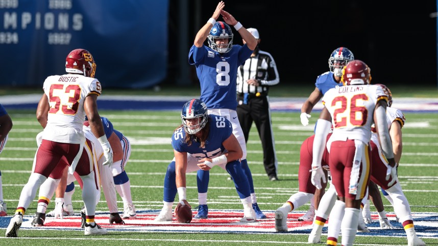 New York Giants quarterback Daniel Jones (8) calls time out behind guard Nick Gates (65) as Washington Football Team linebacker Jon Bostic (53) and safety Landon Collins (26) defend during the second half at MetLife Stadium