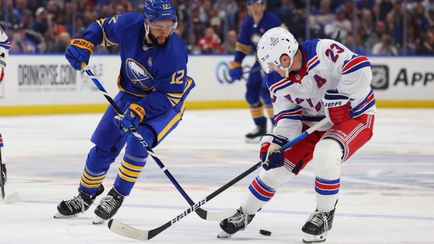 Buffalo Sabres left wing Jordan Greenway (12) and New York Rangers defenseman Adam Fox (23) go after a loose puck during the third period at KeyBank Center