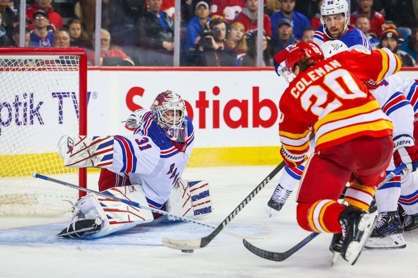 New York Rangers goaltender Igor Shesterkin (31) makes a save against Calgary Flames center Blake Coleman (20) during the second period at Scotiabank Saddledome