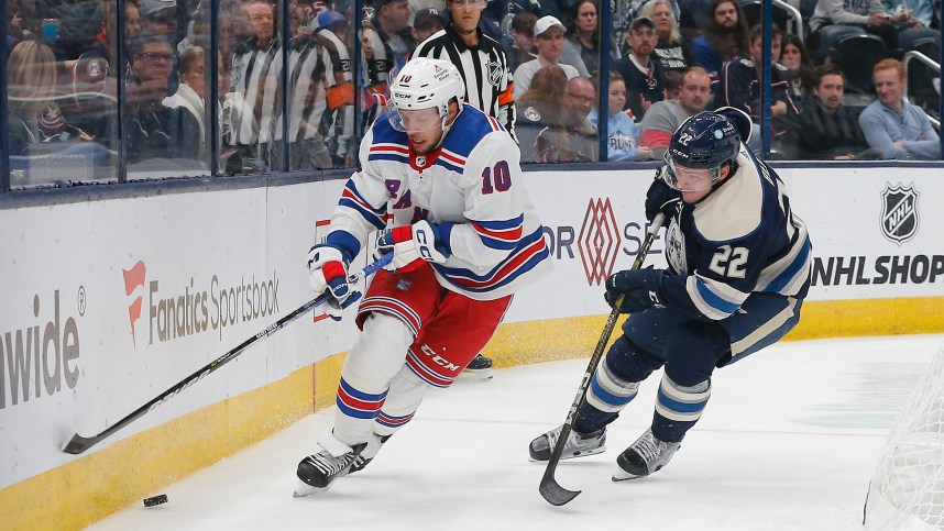 New York Rangers left wing Artemi Panarin (10) skates after a loose puck as Columbus Blue Jackets defenseman Jake Bean (22) trails the play during the third period at Nationwide Arena