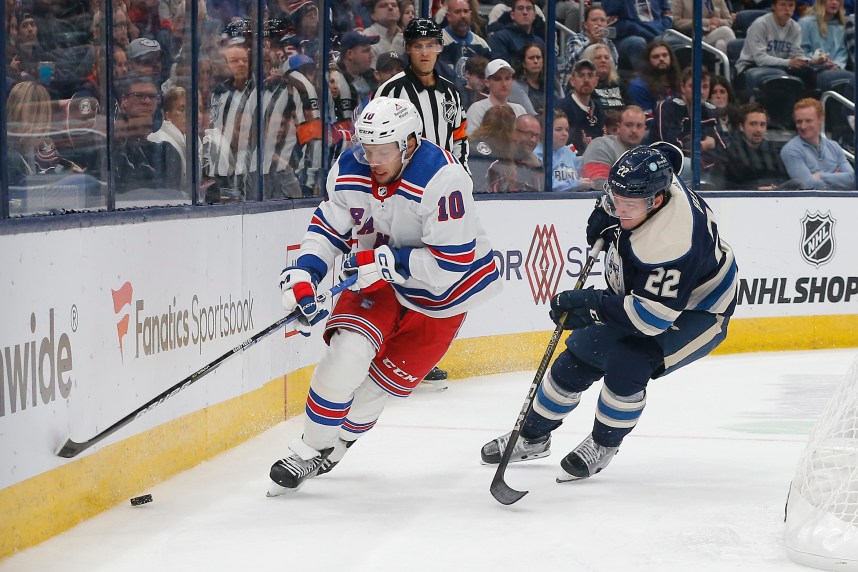 New York Rangers left wing Artemi Panarin (10) skates after a loose puck as Columbus Blue Jackets defenseman Jake Bean (22) trails the play during the third period at Nationwide Arena