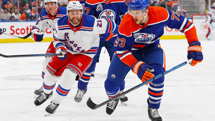 Edmonton Oilers defensemen Vincent Desharnais (73) and New York Rangers forward Barclay Goodrow (21) chase a loos puck during the second period at Rogers Place