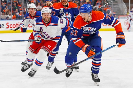 Edmonton Oilers defensemen Vincent Desharnais (73) and New York Rangers forward Barclay Goodrow (21) chase a loos puck during the second period at Rogers Place