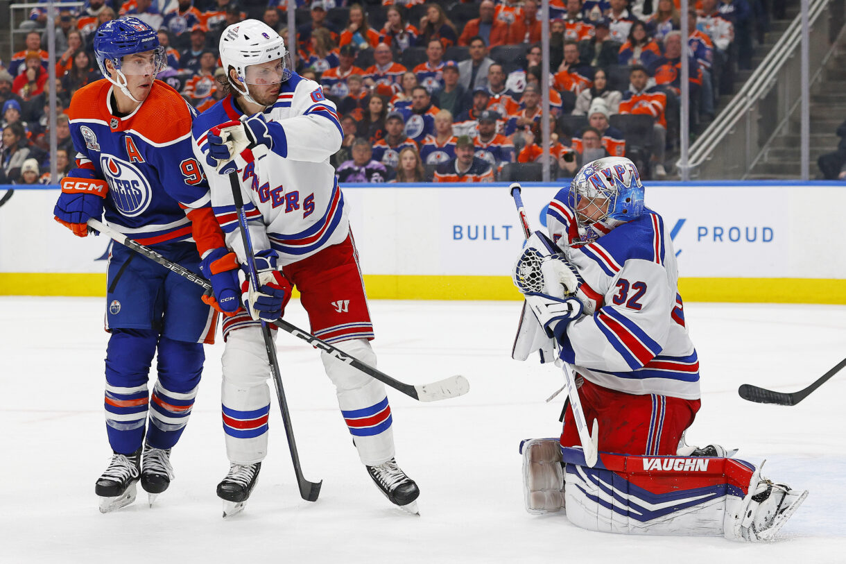 Edmonton Oilers forward Ryan Nugent-Hopkins (93) and New York Rangers defensemen Jacob Trouba (8) battle in front of New York Rangers goaltender Jonathan Quick (32) as he makes a save during the third period at Rogers Place