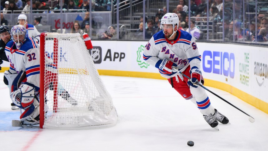 New York Rangers defenseman Erik Gustafsson (56) plays the puck behind the goal during the third period against the Seattle Kraken at Climate Pledge Arena