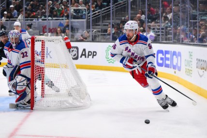 New York Rangers defenseman Erik Gustafsson (56) plays the puck behind the goal during the third period against the Seattle Kraken at Climate Pledge Arena