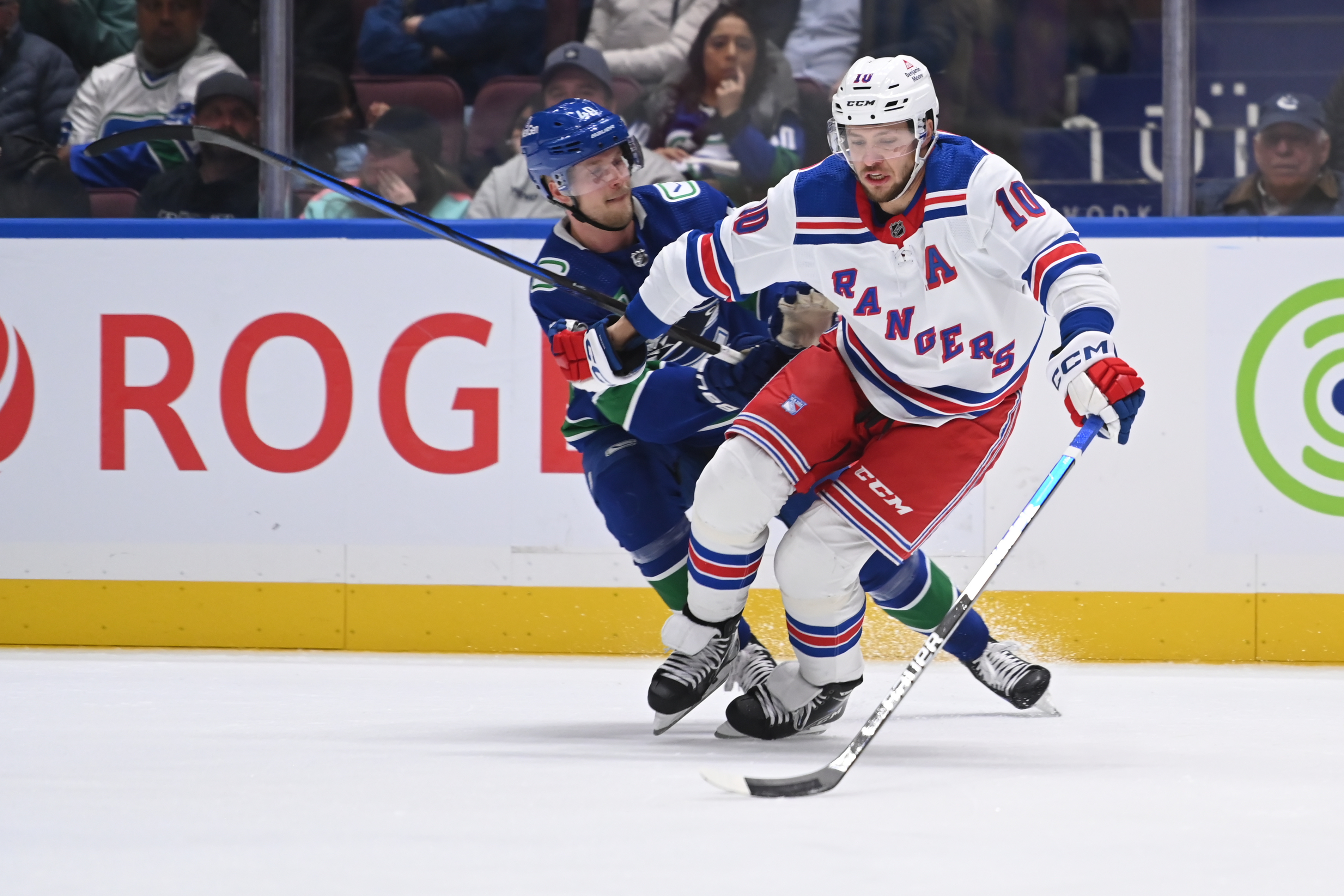 Vancouver Canucks center Elias Pettersson (40) checks New York Rangers left wing Artemi Panarin (10) during third  period at Rogers Arena