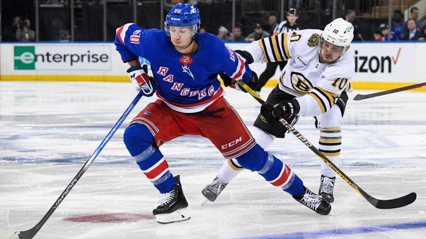 New York Rangers left wing Artemi Panarin (10) skates with the puck defended by Boston Bruins left wing A.J. Greer (10) during the third at Madison Square Garden