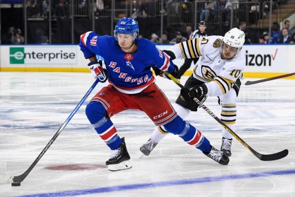 New York Rangers left wing Artemi Panarin (10) skates with the puck defended by Boston Bruins left wing A.J. Greer (10) during the third at Madison Square Garden