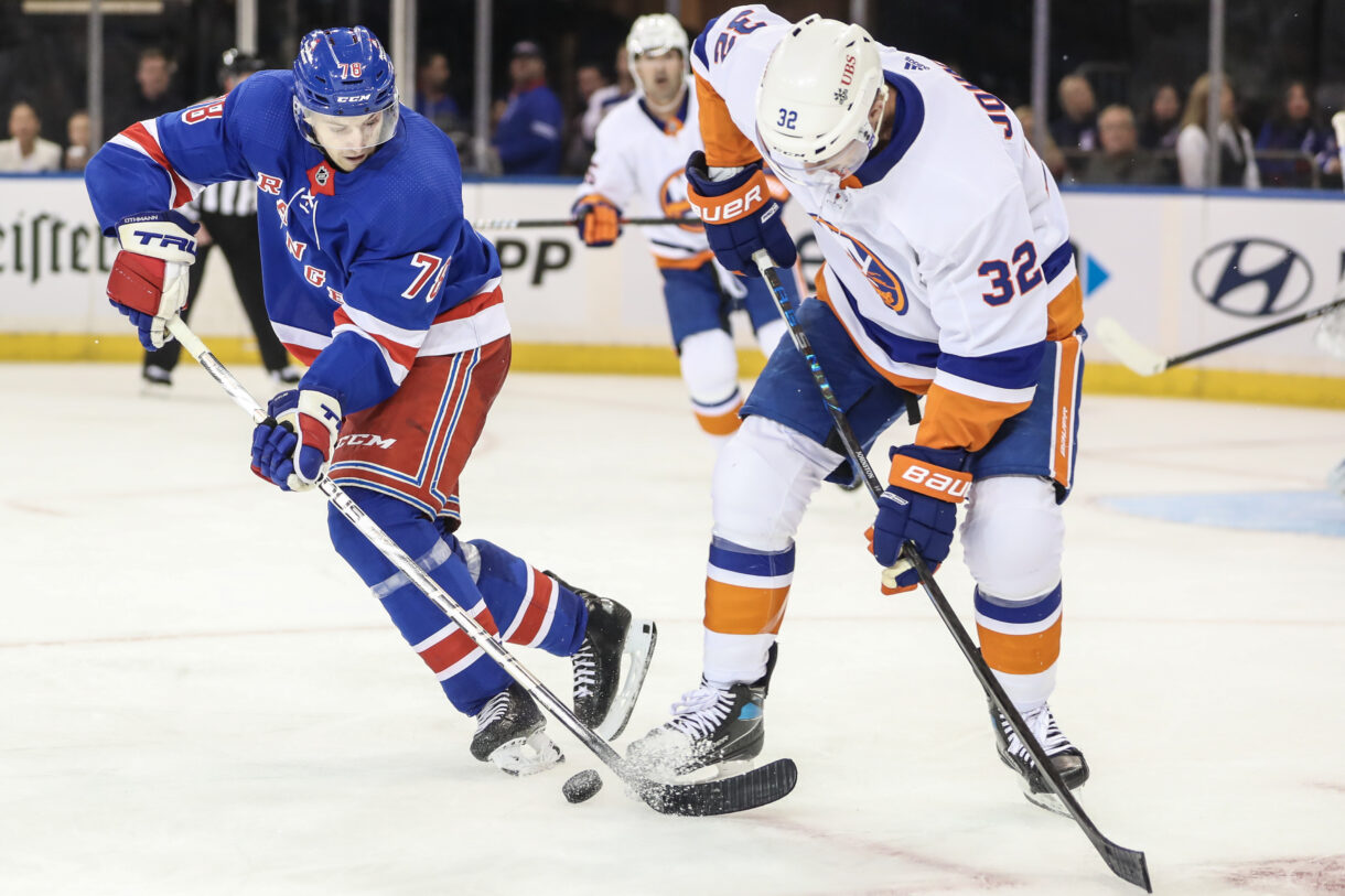 New York Rangers left wing Brennan Othmann (78) and New York Islanders left wing Ross Johnston (32) battle for control of the puck in the third period at Madison Square Garden