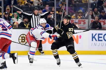 New York Rangers defenseman Matthew Robertson (44) checks Boston Bruins right wing Fabian Lysell (23) during the third period at TD Garden.