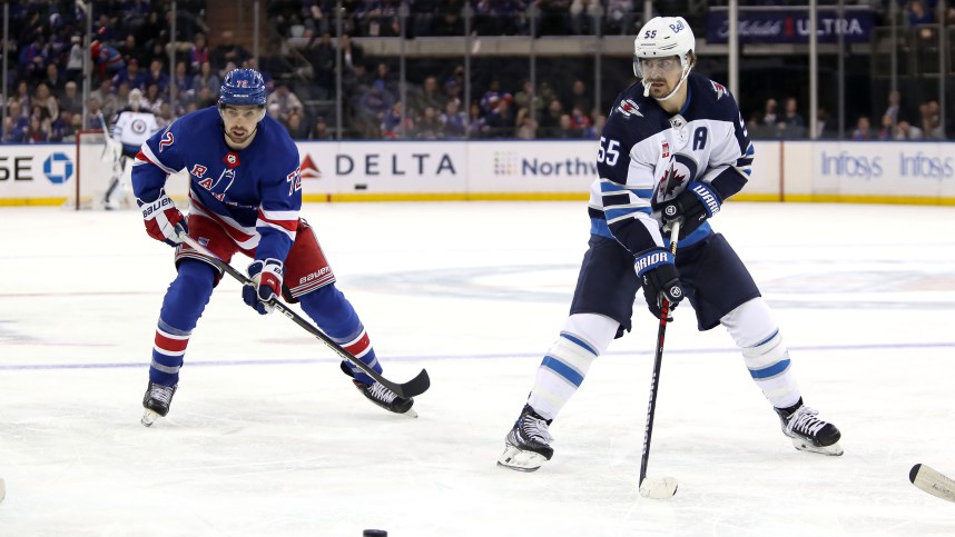 Winnipeg Jets center Mark Scheifele (55) passes the puck in front of New York Rangers center Filip Chytil (72) during the third period at Madison Square Garden