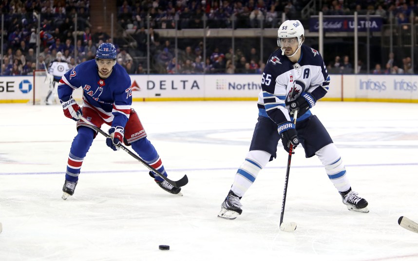 Winnipeg Jets center Mark Scheifele (55) passes the puck in front of New York Rangers center Filip Chytil (72) during the third period at Madison Square Garden