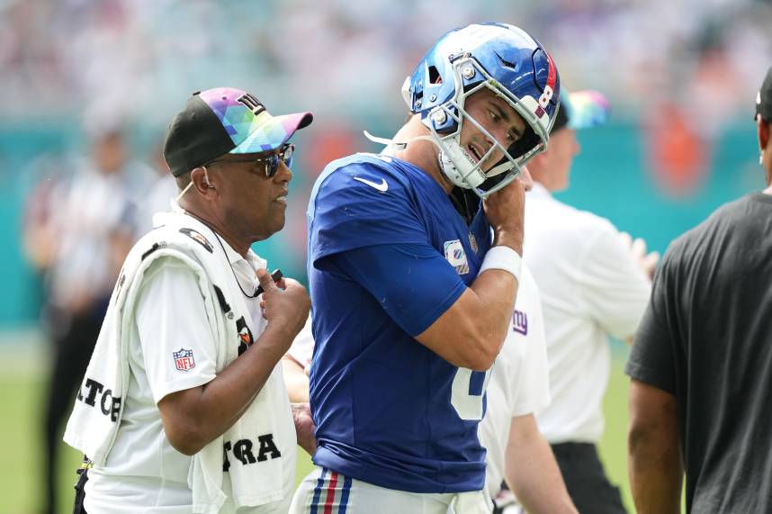 New York Giants quarterback Daniel Jones (8) leaves the game with an injury against the Miami Dolphins during the second half of an NFL game at Hard Rock Stadium in Miami Gardens