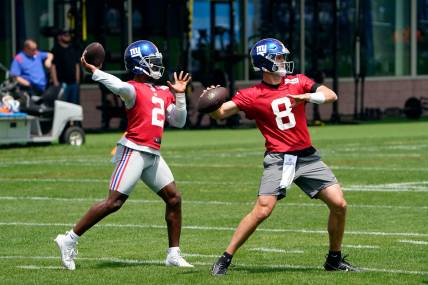 New York Giants quarterbacks Daniel Jones (8) and Tyrod Taylor (2) throw the ball on the first day of mandatory minicamp at the Giants training center in East Rutherford
