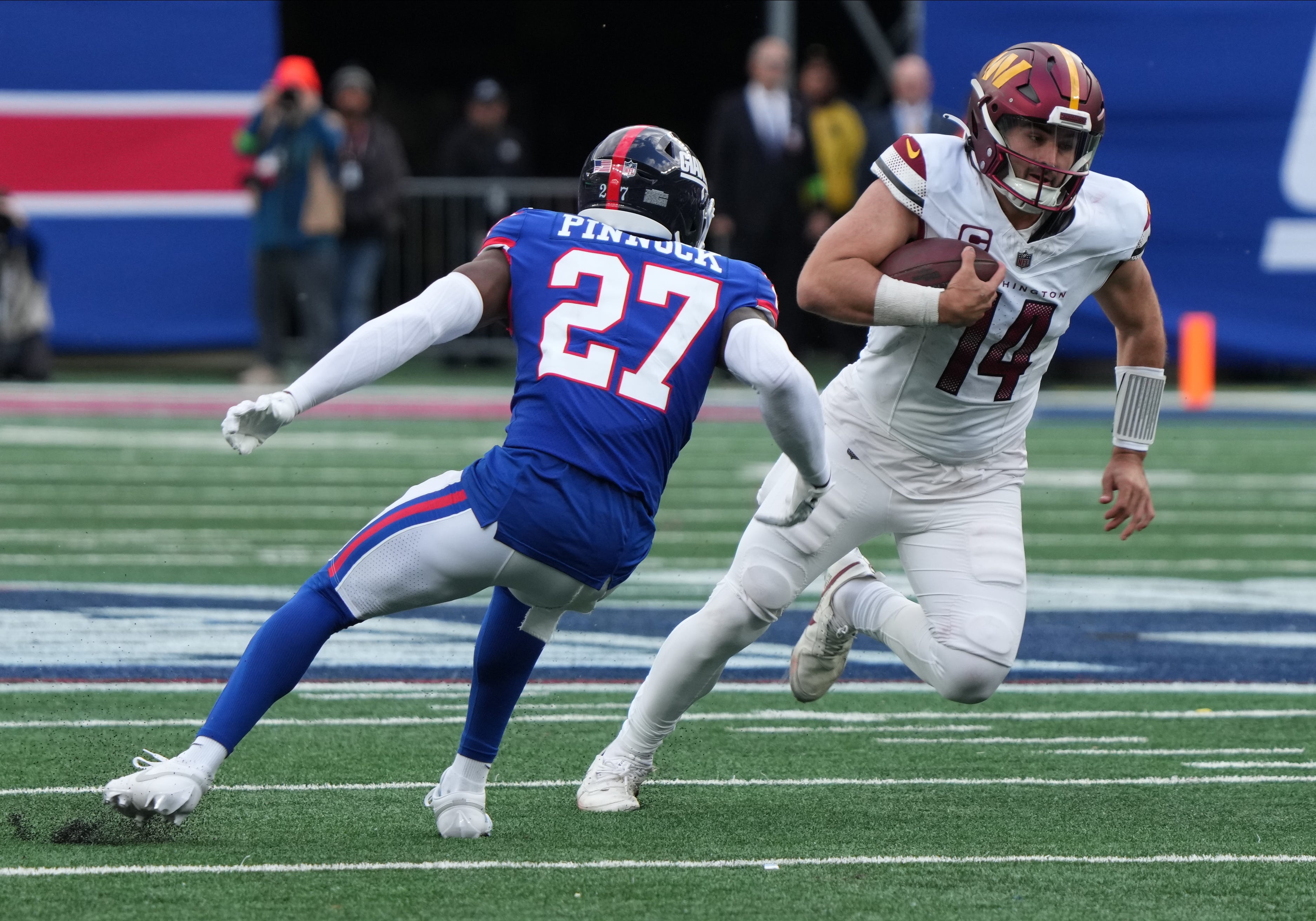 Jason Pinnock of the Giants chases Sam Howell of the Commanders in the second half. The NY Giants host the Washington Commanders at MetLife Stadium