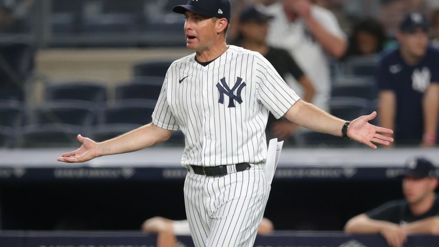 New York Yankees bench coach Carlos Mendoza (64) reacts after being ejected during the tenth inning against the Boston Red Sox at Yankee Stadium (Mets)