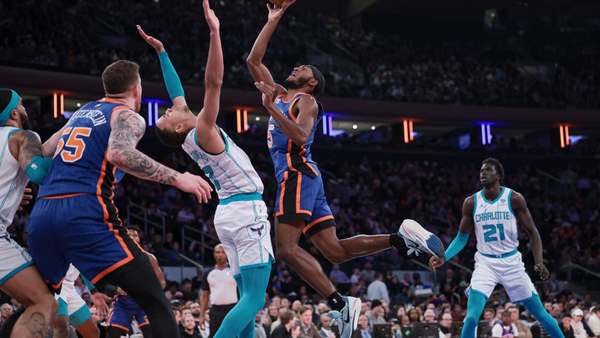 New York Knicks guard Immanuel Quickley (5) drives to the basket as Charlotte Hornets guard Bryce McGowens (7) defends during the first half at Madison Square Garden