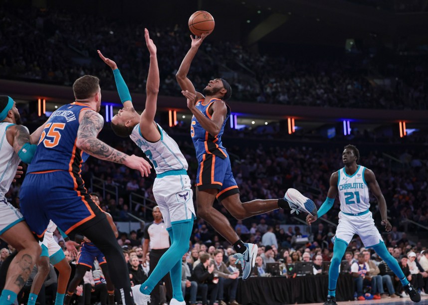 New York Knicks guard Immanuel Quickley (5) drives to the basket as Charlotte Hornets guard Bryce McGowens (7) defends during the first half at Madison Square Garden