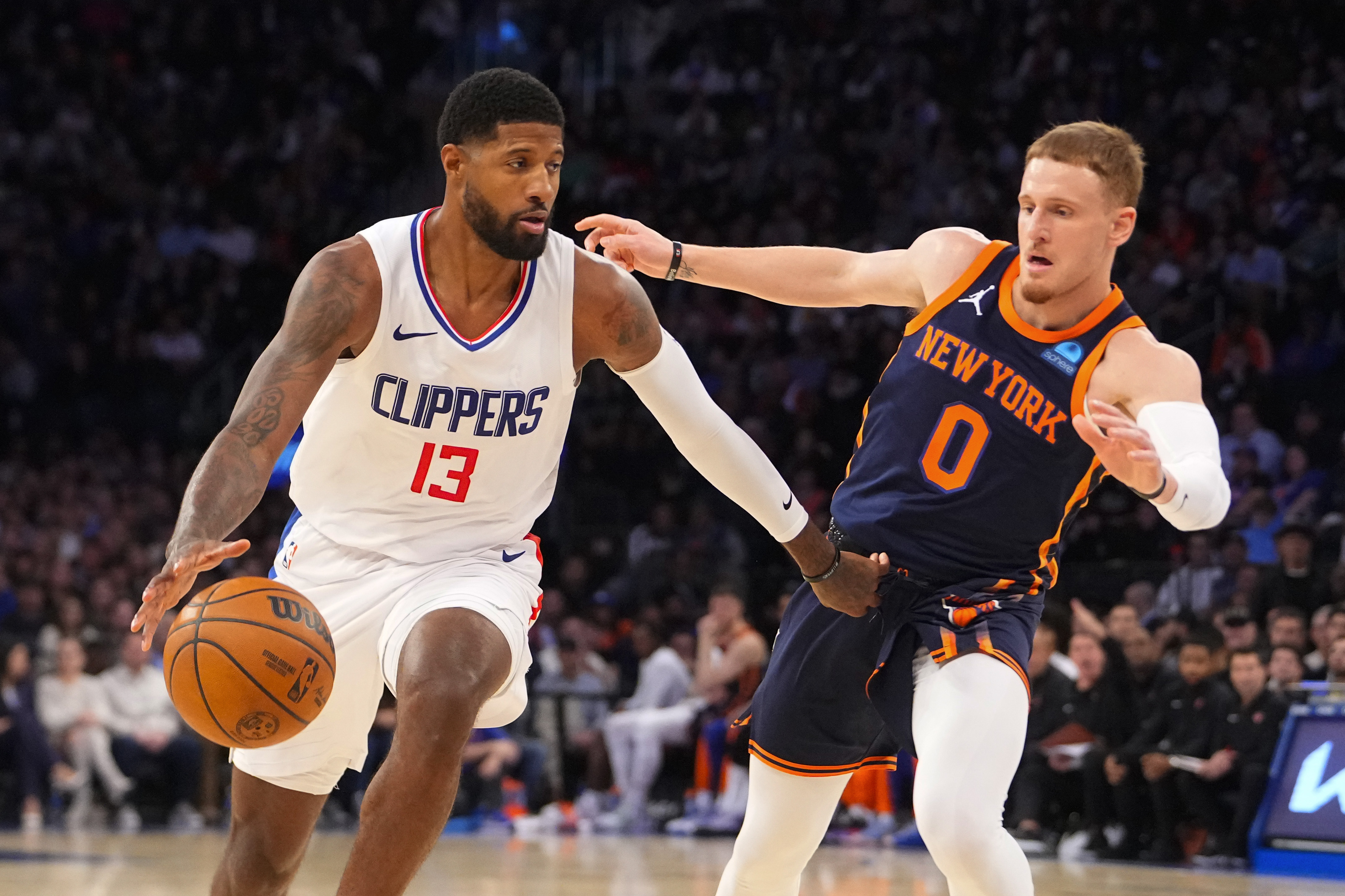 Los Angeles Clipper forward Paul George (13) dribbles the ball against New York Knicks shooting guard Donte DiVincenzo (0) during the fourth quarter at Madison Square Garden