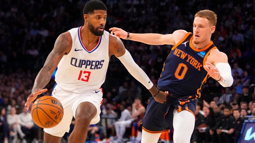 Los Angeles Clipper forward Paul George (13) dribbles the ball against New York Knicks shooting guard Donte DiVincenzo (0) during the fourth quarter at Madison Square Garden