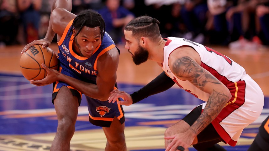 New York Knicks guard Immanuel Quickley (5) controls the ball against Miami Heat forward Caleb Martin (16) during the fourth quarter at Madison Square Garden