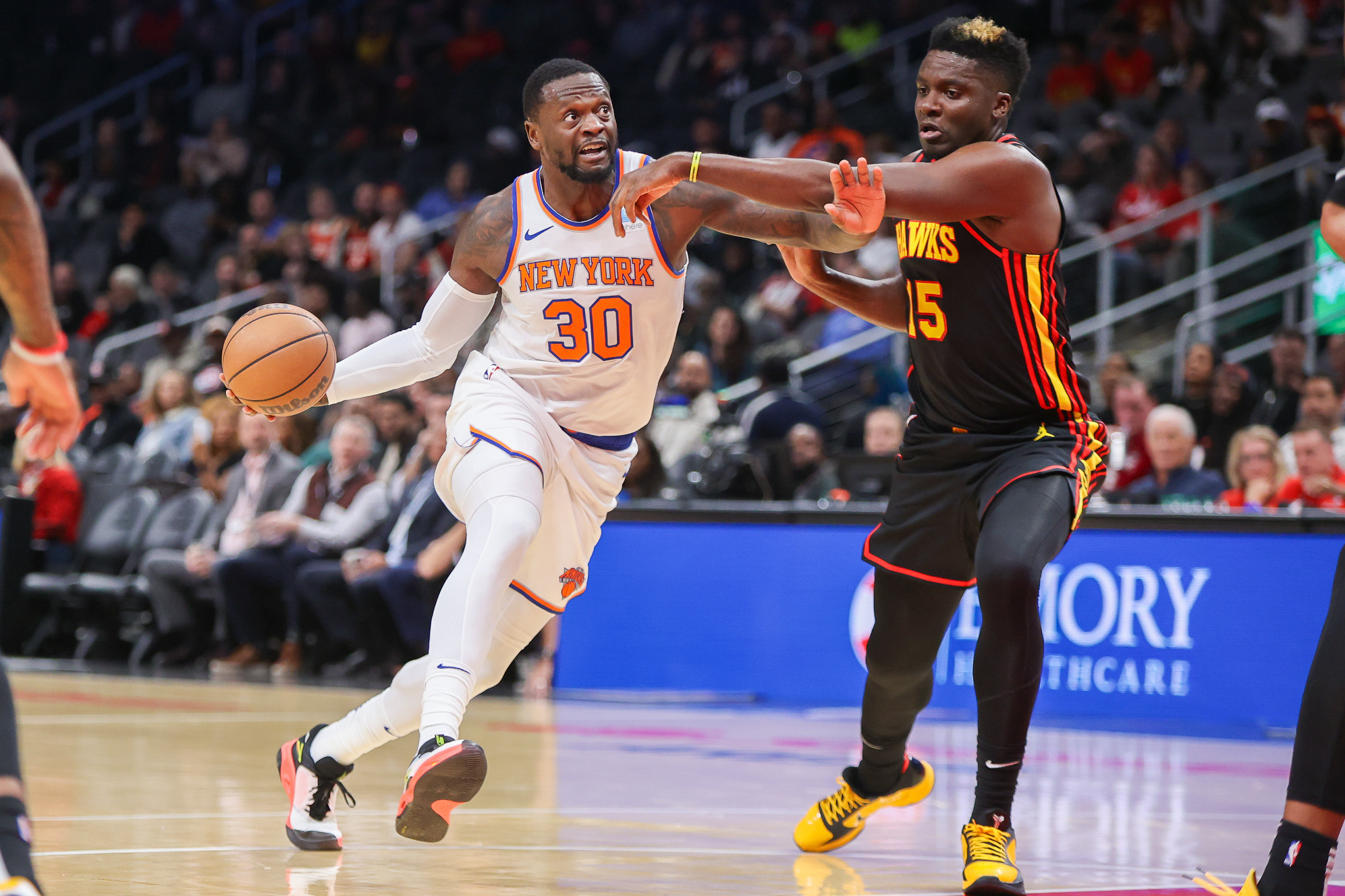 New York Knicks forward Julius Randle (30) drives past Atlanta Hawks center Clint Capela (15) in the first quarter at State Farm Arena